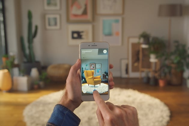 The IKEA app being used to see how a specific yellow chair would look in a living space