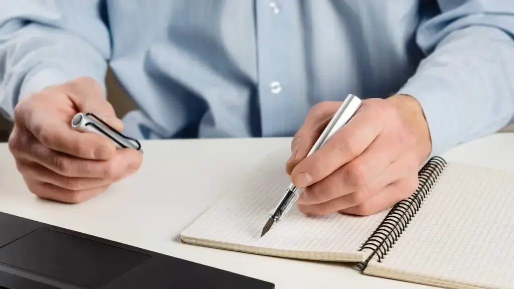 Man writing with Lamy pen