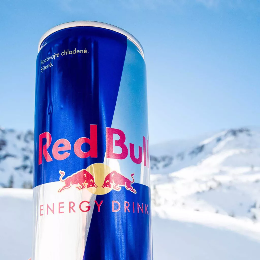 Red bull can with snowy landscape as backdrop