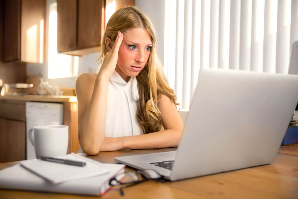 Woman looking concerned about her marketing planning spreadsheet