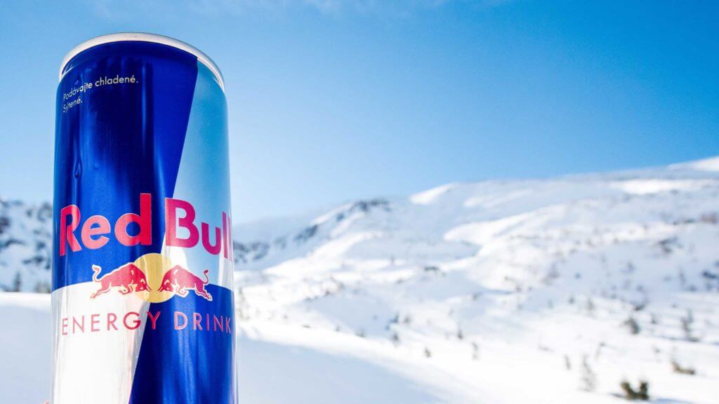 Red bull can with snowy mountains in the background