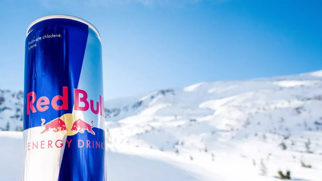 Red bull can with snowy mountains in the background