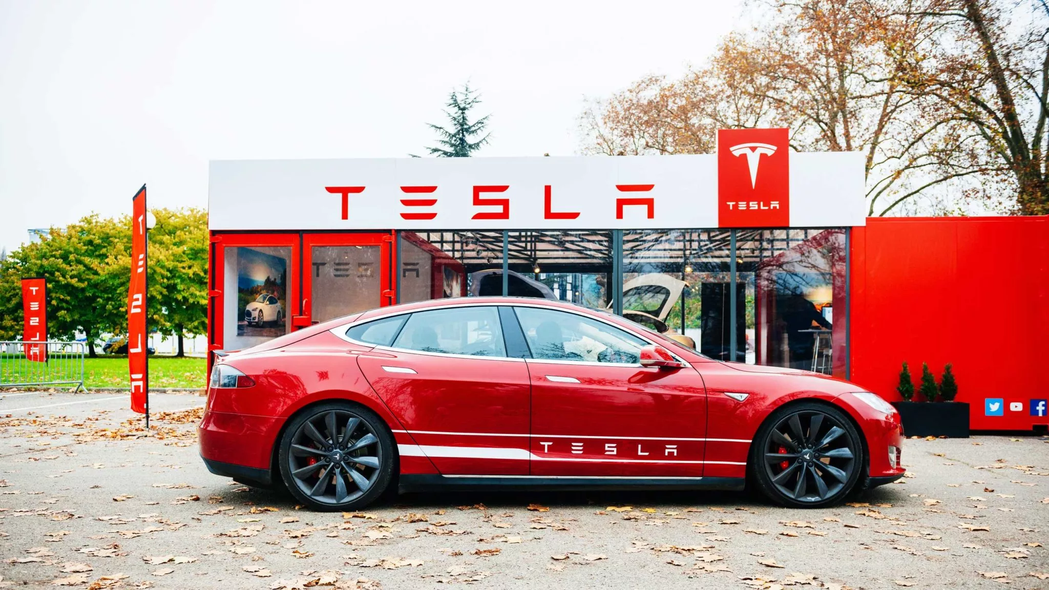 Red Tesla car outside Tesla shop