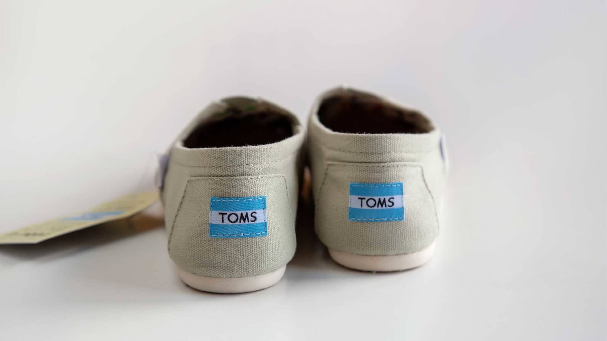 A pair of grey Toms shoes
